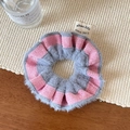 Detailed view of pink and grey striped plush scrunchie with designer brand woven label - Pink