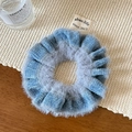 Close-up of blue textured crochet scrunchie made of soft plush velvet and knit fabric - Blue
