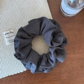Detailed view of dark grey striped scrunchie on a wooden desk with a perfume bottle - Gray Double Layer