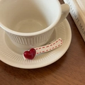 Detailed close-up of a sweet Korean style white hair clip with a red shiny heart and polka dots - Heart Style