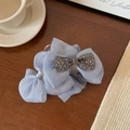 Detail of blue organza bow hair claw clip with sparkling rhinestones and glitter finish - 13cm / Blue