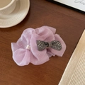 Macro shot of purple mesh ribbon hair claw with sparkling crystal bow on wooden table - 11cm / Pink