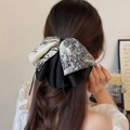 Elegant French vintage print ribbon hair clip with a stylish black and white bow design - Printed Ponytail Clip