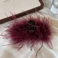 Close-up of fluffy burgundy ostrich feathers on a black hair claw clip for elegant styling - 11cm / Burgundy