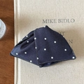 Three-dimensional navy blue fabric mask with white polka dots and visible stitching - Polka Dot Hair Clip / Navy Blue