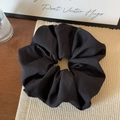 Macro detail of black fabric scrunchie showing high-density woven texture and matte finish - Black