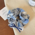 Dettaglio di elastico scrunchie a quadri blu e bianchi con pizzo e fiocco di raso - Quadri Blu