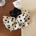 Detailed view of oversized polka dot scrunchie with pearls on a wooden texture surface - Beige Polka Dot