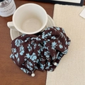 Elegant brown floral bow hair claw clip with white pearl accents on a wooden desk - Blue Print Ponytail Clip