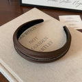 Detailed macro view of the dark brown thick padded headband with elegant crystal beads - Brown