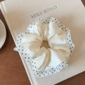 Detail of cream satin hair scrunchie with polka dot mesh trim on a vintage book surface - Single Layer White Polka Dot