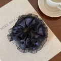 Detail of navy blue polka dot scrunchie with black lace trim on a canvas book - Denim Blue