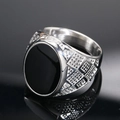 Macro view showing black oval gemstone and geometric textured band of silver ring - US 7 / Steel