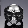 Macro view of vintage stainless steel skull ring with detailed bone joint band design - US 7 / Steel