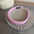 Close-up of pink padded sponge headband with handmade label on a stylish beige tray - Pink