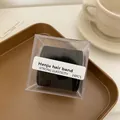 Set mit 24 schwarzen hochelastischen Haargummis in Klarsichtbox für Damenpferdeschwänze - Köper-Schwarz