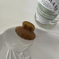 Detail of a minimalist amber-colored hair claw clip placed on a white porcelain plate - Coffee-Small Oval