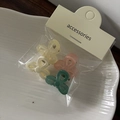 Close-up of 4 mini translucent butterfly hair clips in mixed colors on a white plate - Bright Color Mini Bow