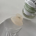Detail of a small translucent pink resin hair claw clip on a white textured ceramic plate - Beige-Small Oval