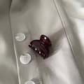 Close-up of a glossy deep burgundy mini hair claw clip placed on a beige blazer fabric - Burgundy Fan