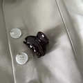 Detailed view of mini tortoiseshell hair claw clip on a stylish beige blazer texture - Dark Gray Fan