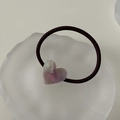 Close-up of a purple heart-shaped resin charm on an elastic hair tie in a white tray - Phantom Purple