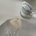 Detail of a minimalist apricot resin triangle hair claw clip on a decorative white porcelain plate - Beige-Triangle