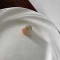 Close-up of heart-shaped mini hair claw clip with orange and teal marble texture - Orange Green
