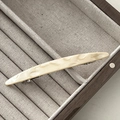 Close-up of cream marble resin barrette on linen display with silver spring metal clip - Beige Oval Style