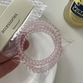 Close-up of translucent pink spiral telephone wire hair ties in retail packaging - Spiral Hair Ties Set / Pink
