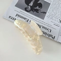 Detailed macro view of the iridescent cream acetic hair claw with France Handmade text - Mermaid White