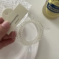 Close-up of a clear spiral telephone wire hair tie with accessories tag in a bag - Spiral Hair Ties Set / Beige