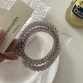 Close-up of translucent grey spiral hair ties in transparent packaging with card - Spiral Hair Ties Set / Gray