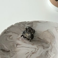 Detail of marble gray hair claw with golden France Handmade logo on a stone tray - Gray