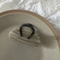 Macro detail of high-quality marbled claw clip hair accessory in a ceramic dish - Gray