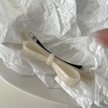 Detail of beige acetate bow hair clip with pearlescent finish on white background - Mermaid White