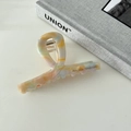 Detail of elegant acetate hair claw clip with colorful marble pattern and metal spring - Yellow Blue