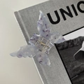 Detail of butterfly hair claw clip with purple marble texture on a stylish magazine - Light Purple