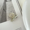 Detail of pearlescent green acetate hair claw clip with marble texture on open magazine - Mermaid White