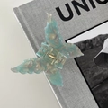 Detail of blue iridescent butterfly hair claw clip with acetate marble texture - Mint Green
