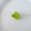 Detailed close-up of lime green acetate hair claw clip with golden France Handmade logo - Green