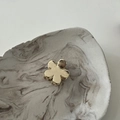 Macro detail of a small golden flower hair claw clip with a matte brushed metal finish - Flower Gold
