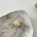 Close-up of small matte gold metal hair claw clip with a brushed texture finish - Trapezoid Gold