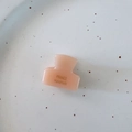 Detailed close-up of a mini pink acetate hair claw clip with gold France Handmade logo - Orange Pink