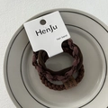 Detail showing elastic hair bands in brown and coffee tones on a white porcelain tray - Leather Patch Brown
