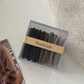 Detail of 10-piece gradient elastic hair ties set in a clear box with handmade label - Basic Black Coffee