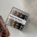 Set of 8 premium elastic hair ties in earthy tones neatly stored in an acrylic box - Milk Coffee Twist