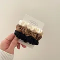 Three-piece set of satin hair scrunchies in cream, brown, and black colors for daily hair styling - White Coffee Black