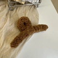 Close-up of brown plush faux fur hair claw clip on soft textured fabric background - Light Coffee