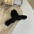 Detailed view of black plush faux fur hair claw clip resting in a metal basket - Sherpa-Black